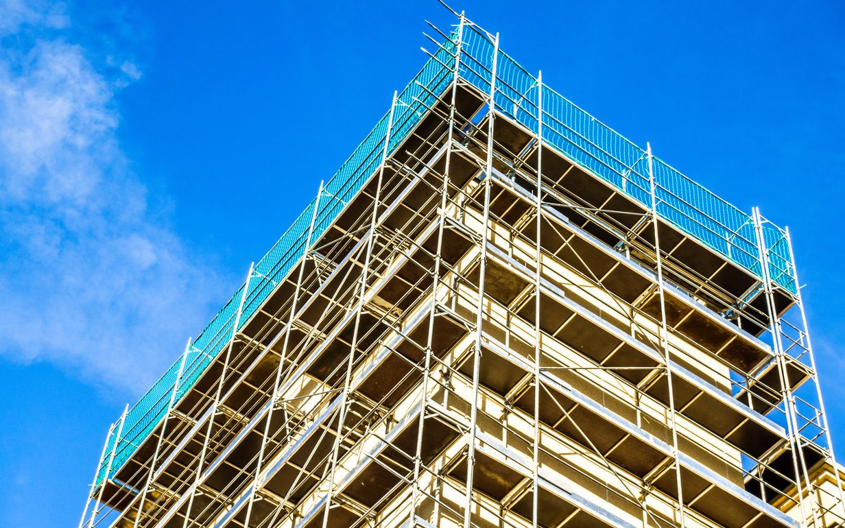 Scaffolding erected around a building under construction